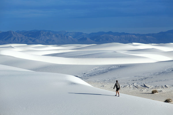 Man Walking On Sand Dunes in White Sands National Park New Mexico