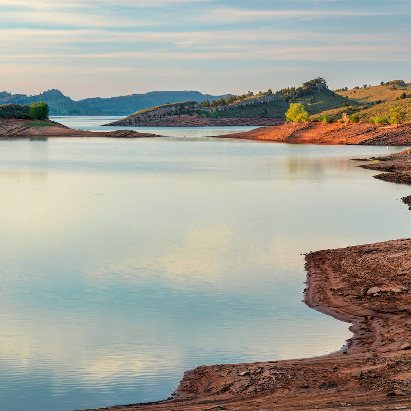 View of calm Horsetooth Reservoir from shoreline in Lory State Park near Northern Colorado