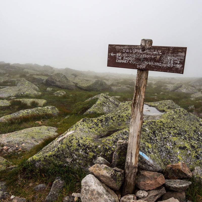 Weathered wooden sign along rocky Katahdin slope in Baxter State Park Maine