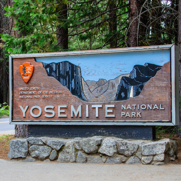 Yosemite National Park sign with trees in background